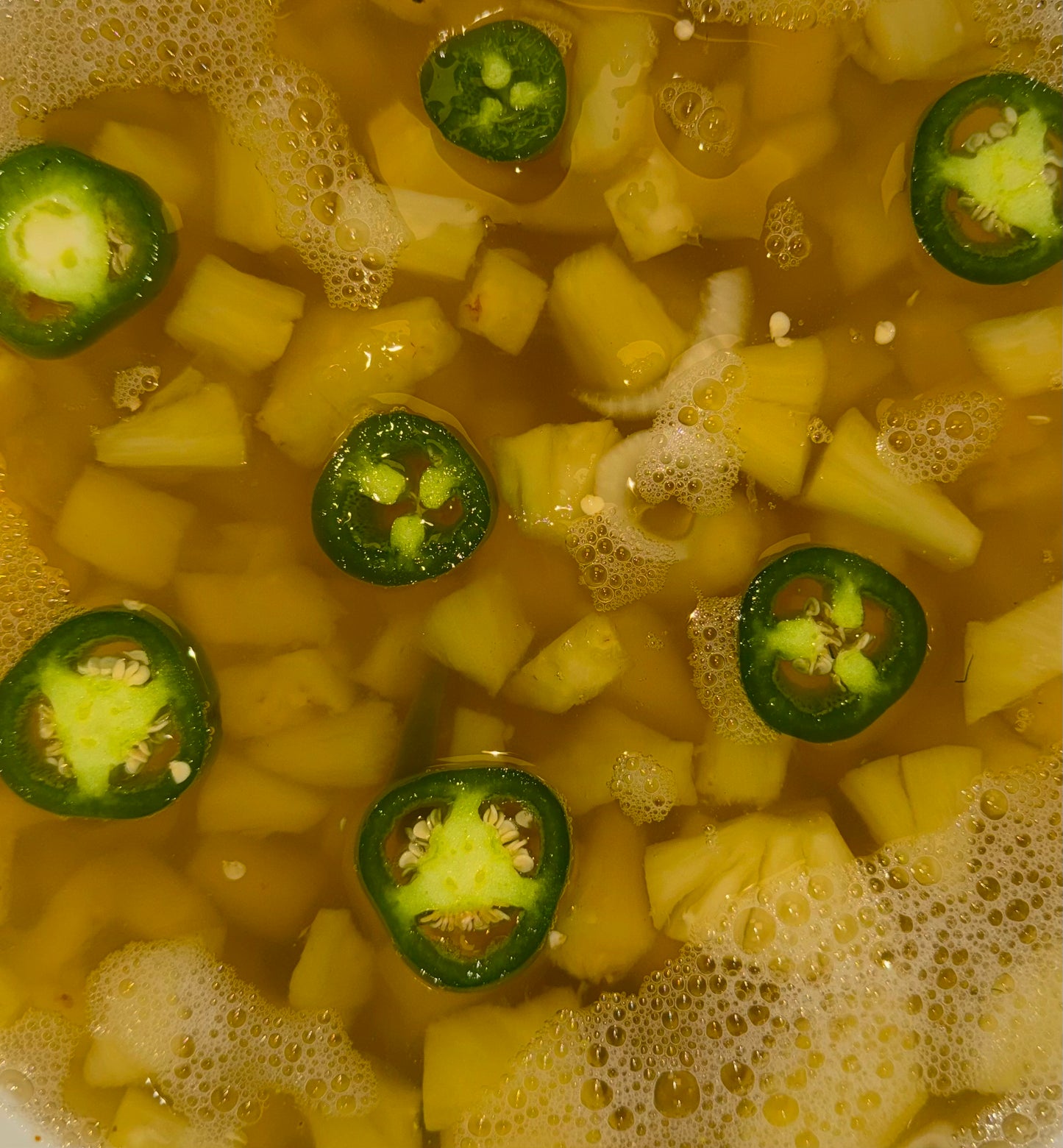 Pineapple chunks and jalapeño slices in brine